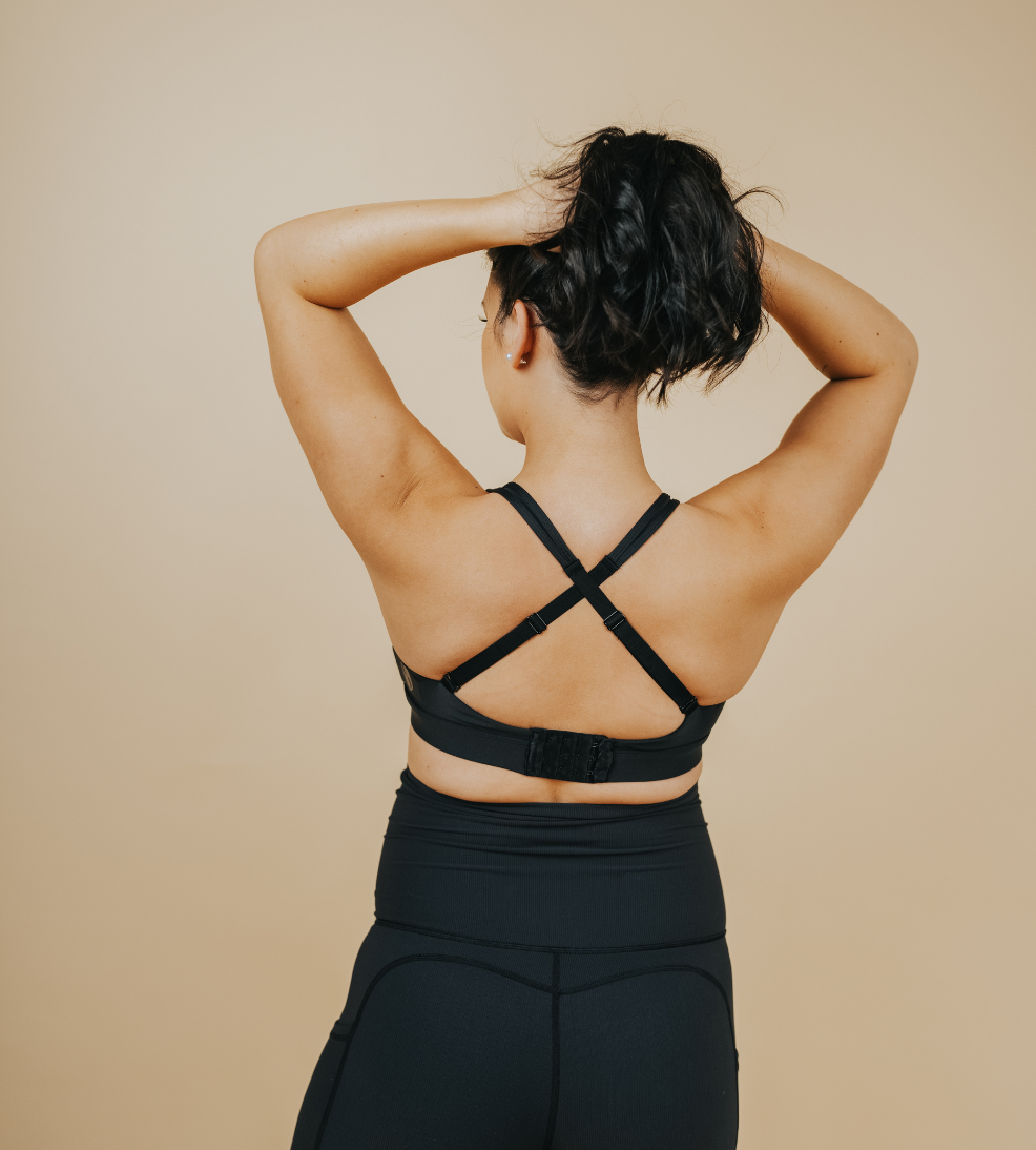 Back view of active mum wearing black nursing sports bra