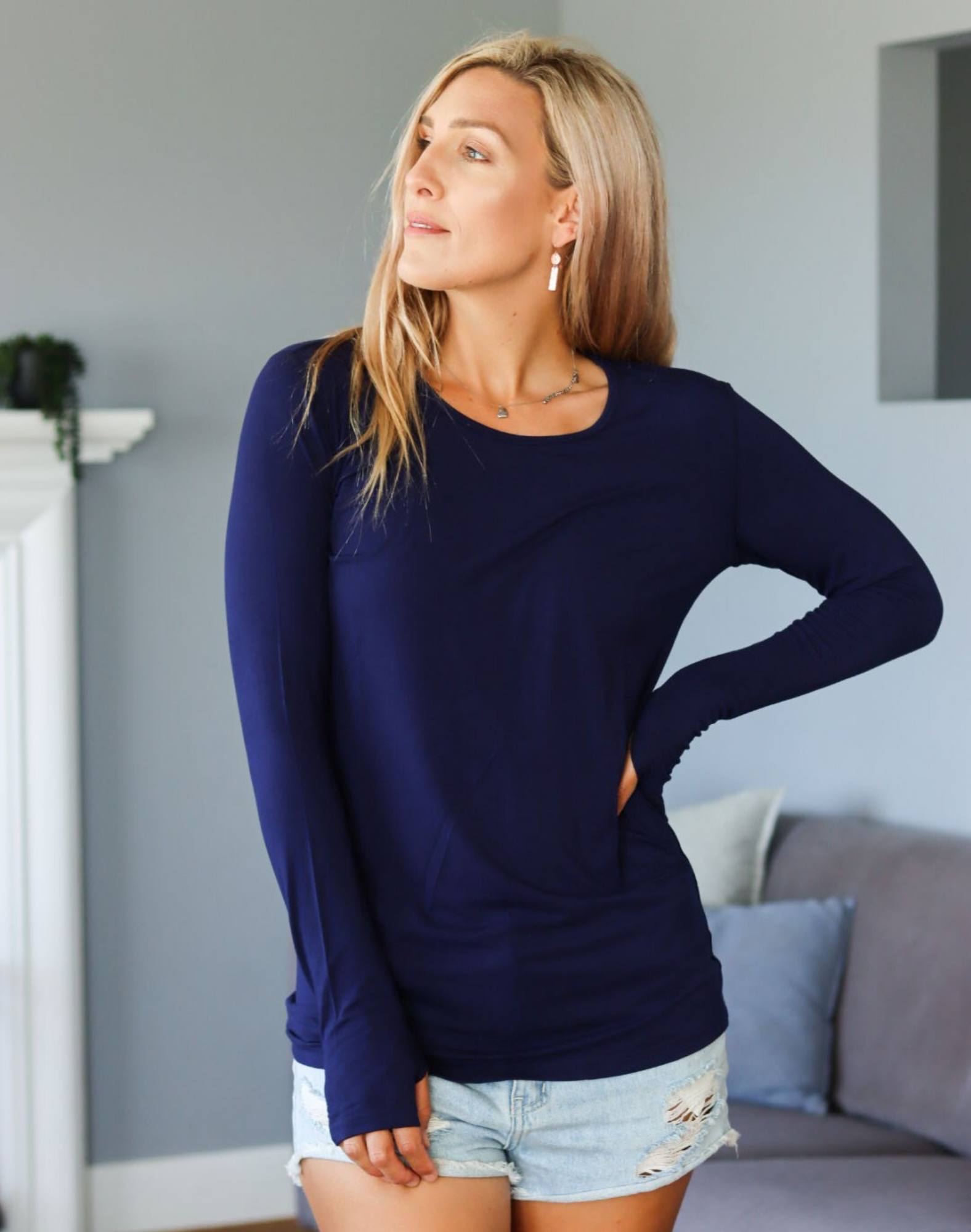 Side view of mum wearing blue activewear long sleeve top