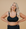 Front view of breastfeeding mum wearing black nursing sports bra