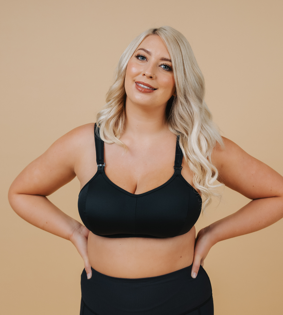 Front view of breastfeeding mum wearing black nursing sports bra