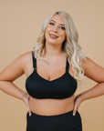 Front view of breastfeeding mum wearing black nursing sports bra