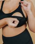 Side view of breastfeeding mum wearing high impact nursing sports bra