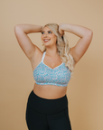 side on view of a happy mum wearing a confetti nursing sports bra