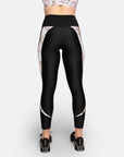 back view of high waisted black postpartum compression tights with white floral detailing