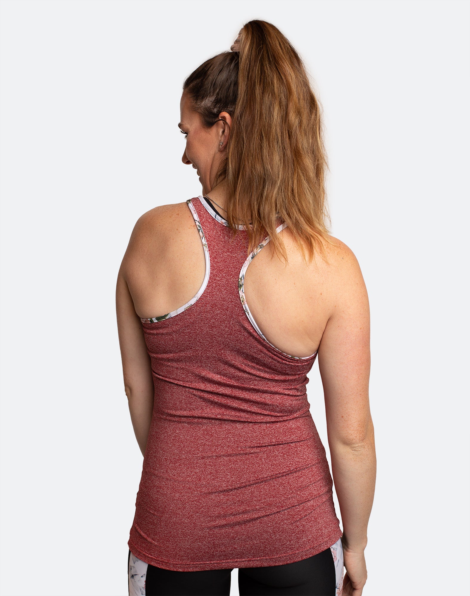 Back view of active mum wearing berry breastfeeding tank