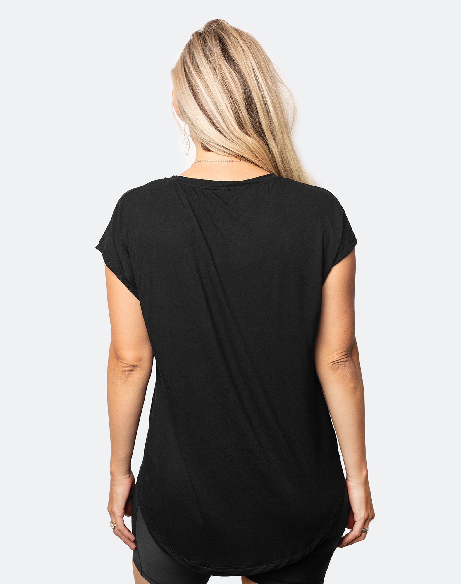 back view of active mum wearing a relaxed fit black tee with wide armholes for breastfeeding