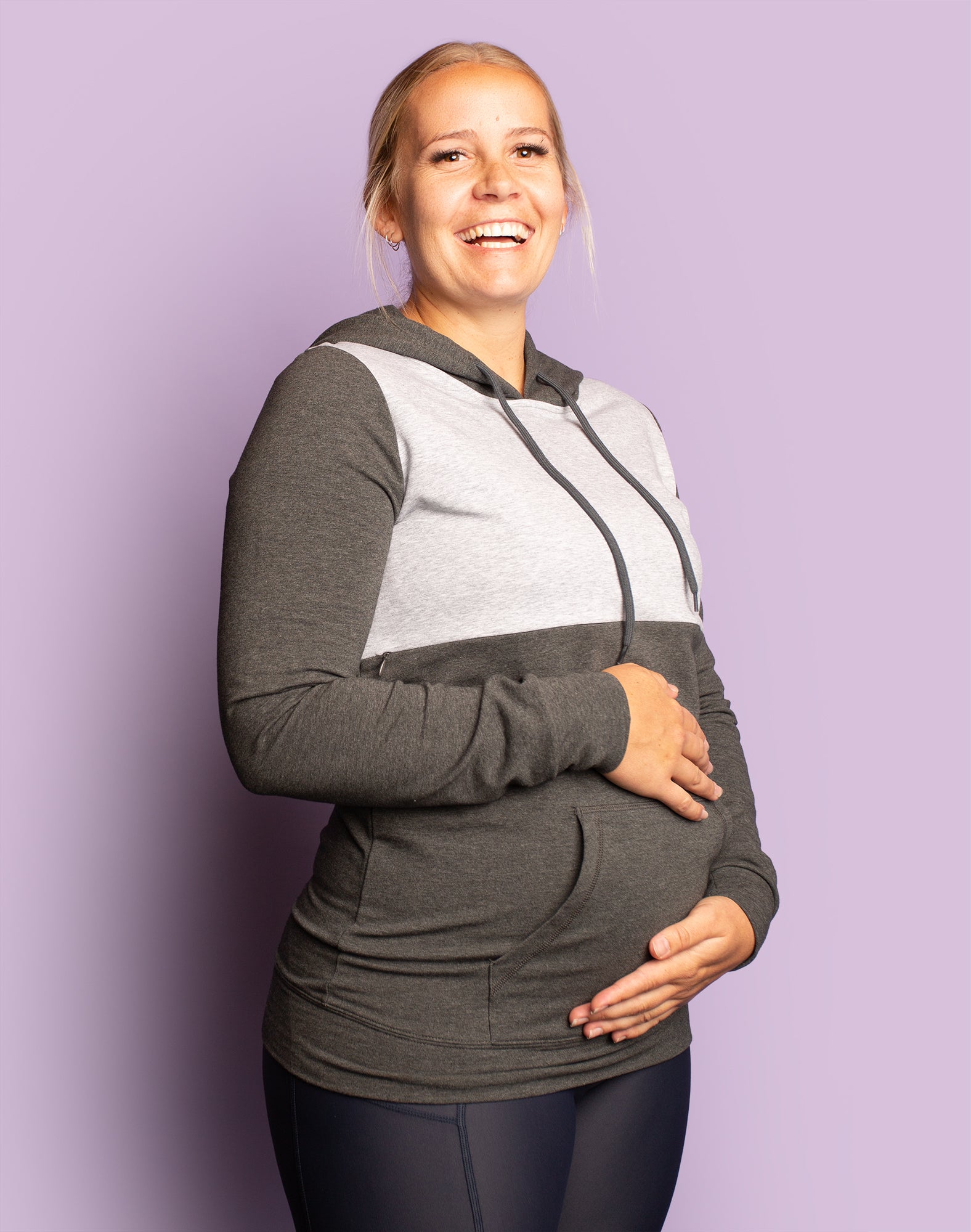 Expecting mother wearing a pregnancy & nursing sweater in grey