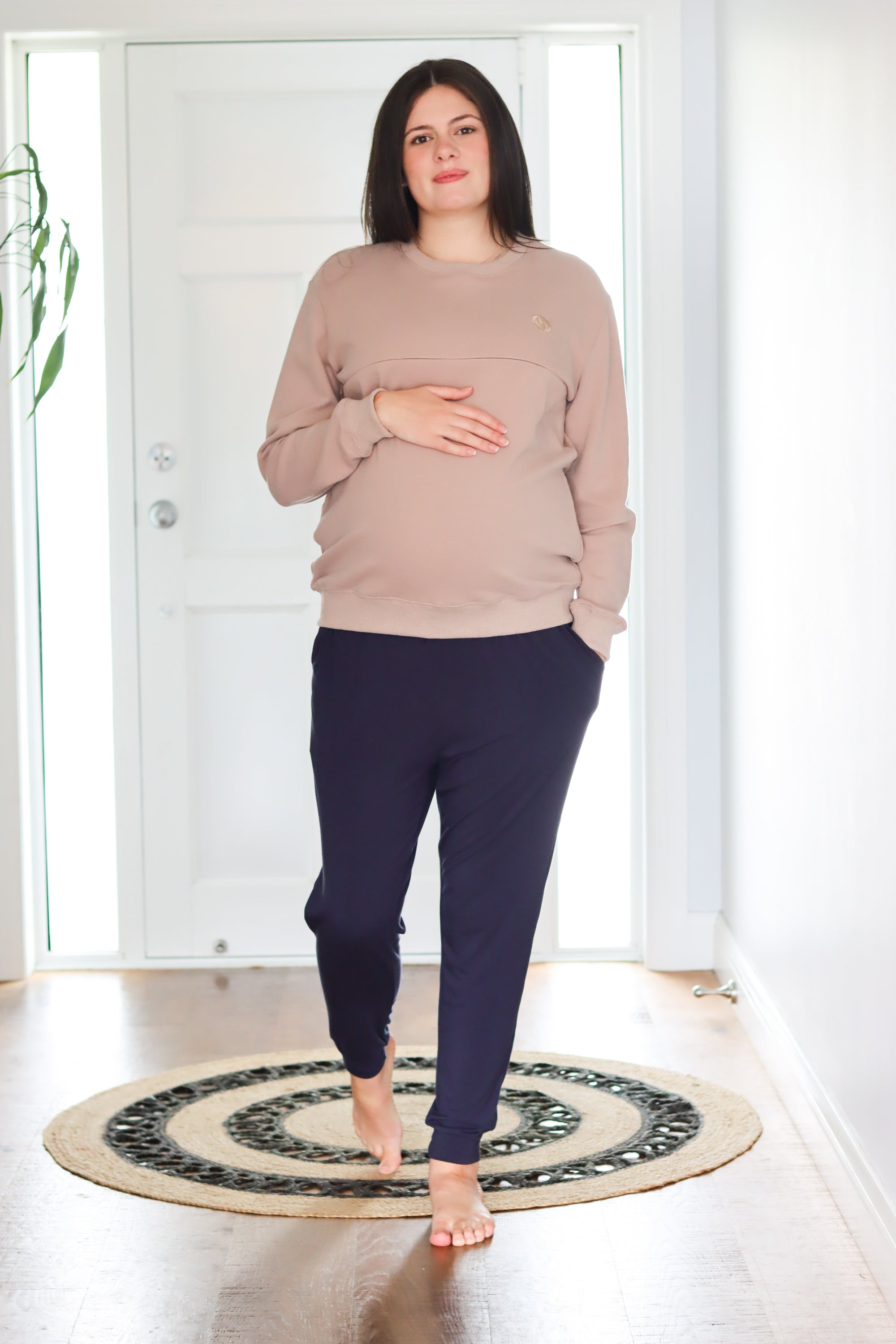 Expecting mother wearing a light brown breastfeeding sweatshirt