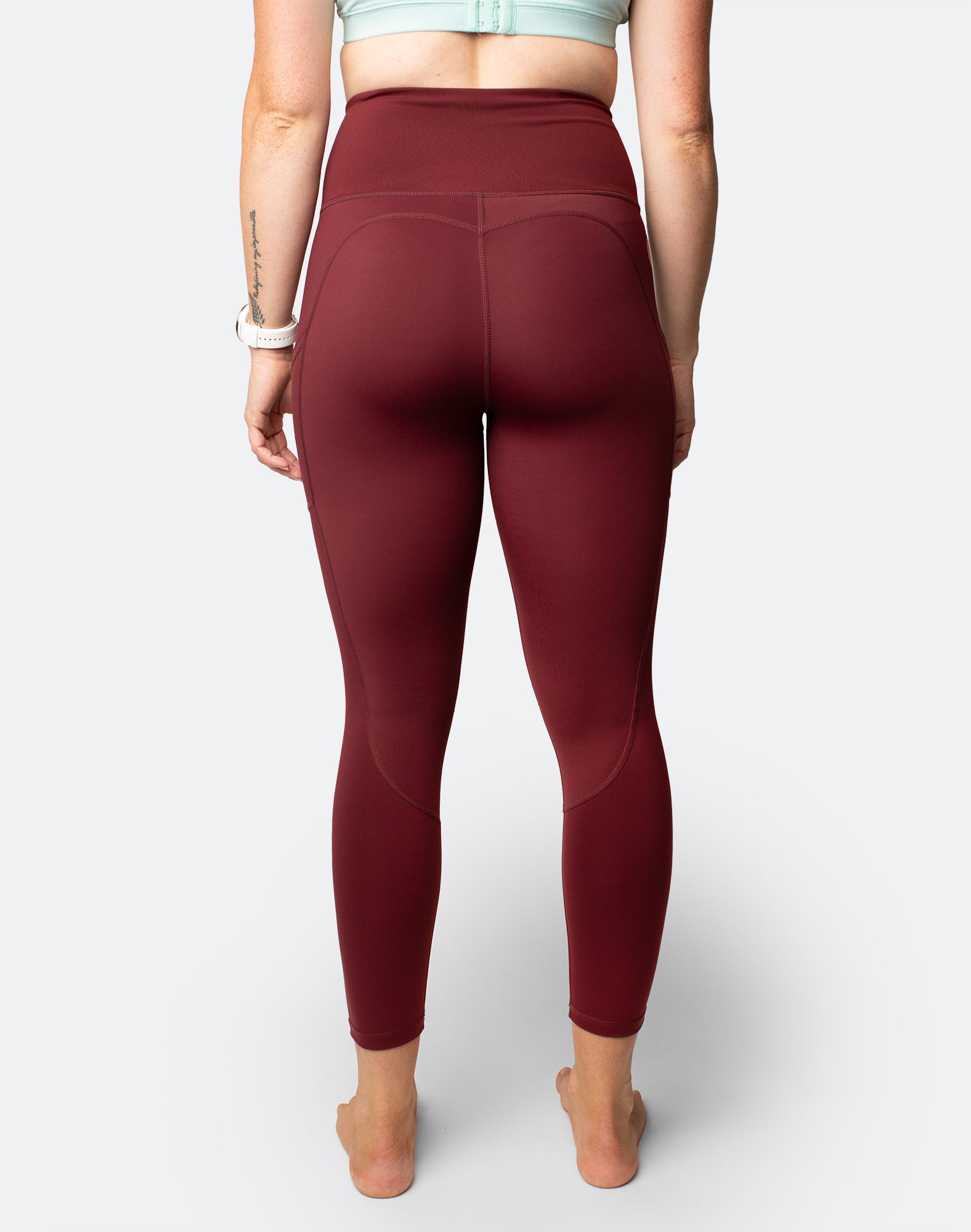 Back view of active mum wearing 7/8 high waisted leggings