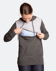 Mother demonstrating the nursing zip on pregnancy & nursing sweater