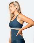 Side on view of active mum wearing aspen nursing bra