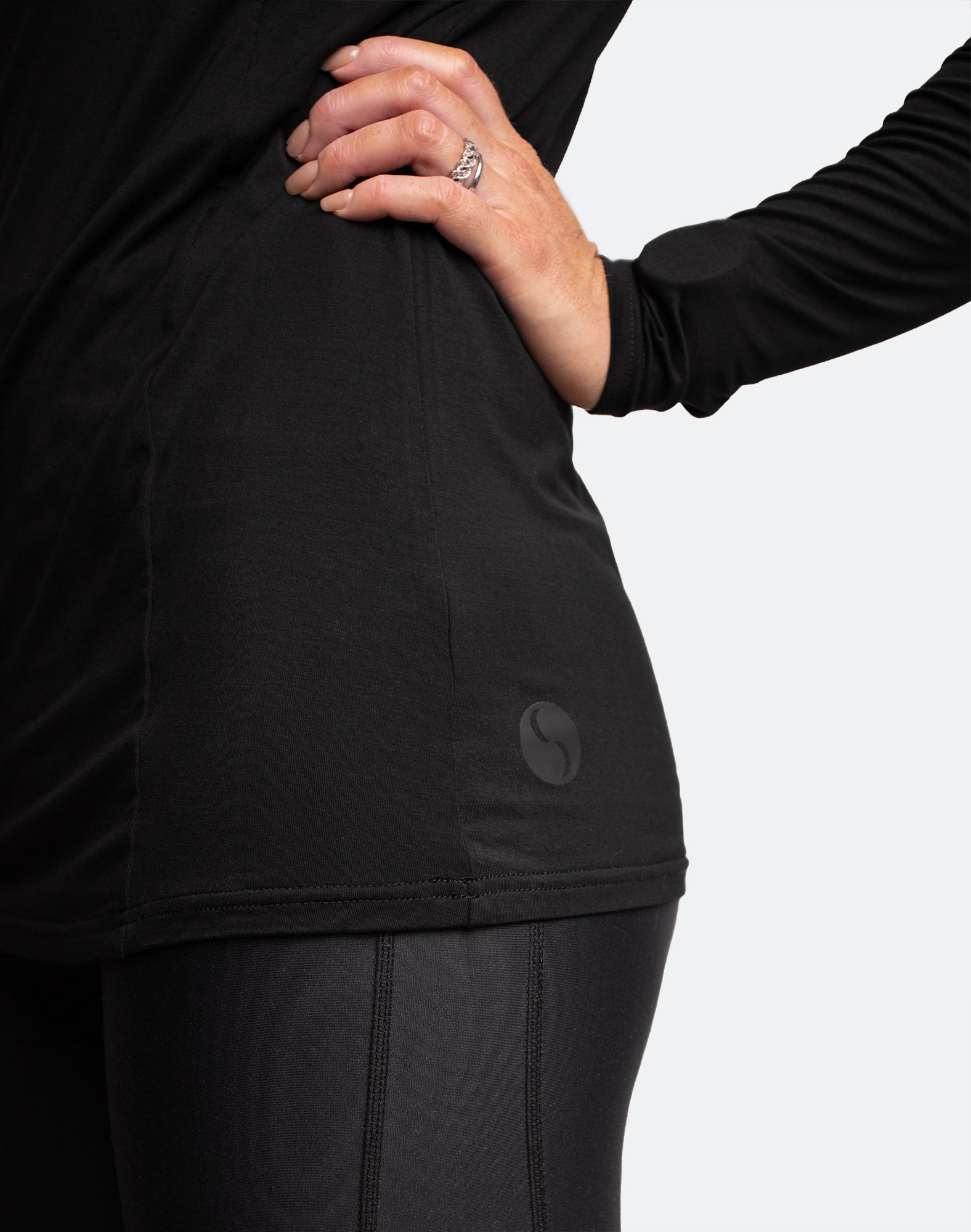 close up view of cadenshae logo on black nursing top