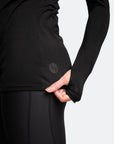 active mum withe brown hair wearing a black maternity top with long sleeves back view