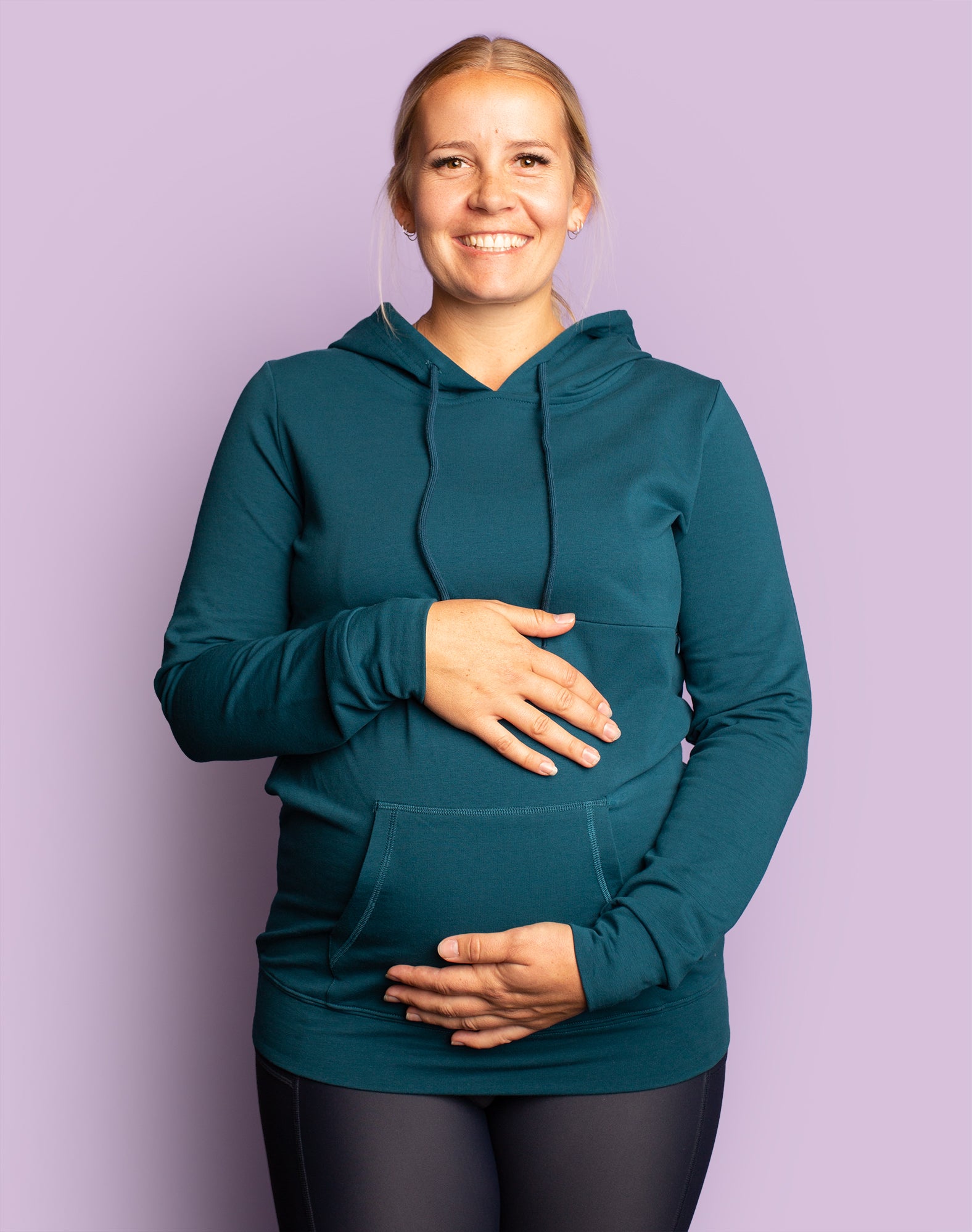 Expecting mother wearing teal nursing hooded sweatshirt