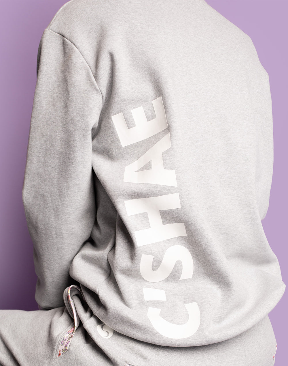 Back view of grey women's crew sweatshirt and trackpants