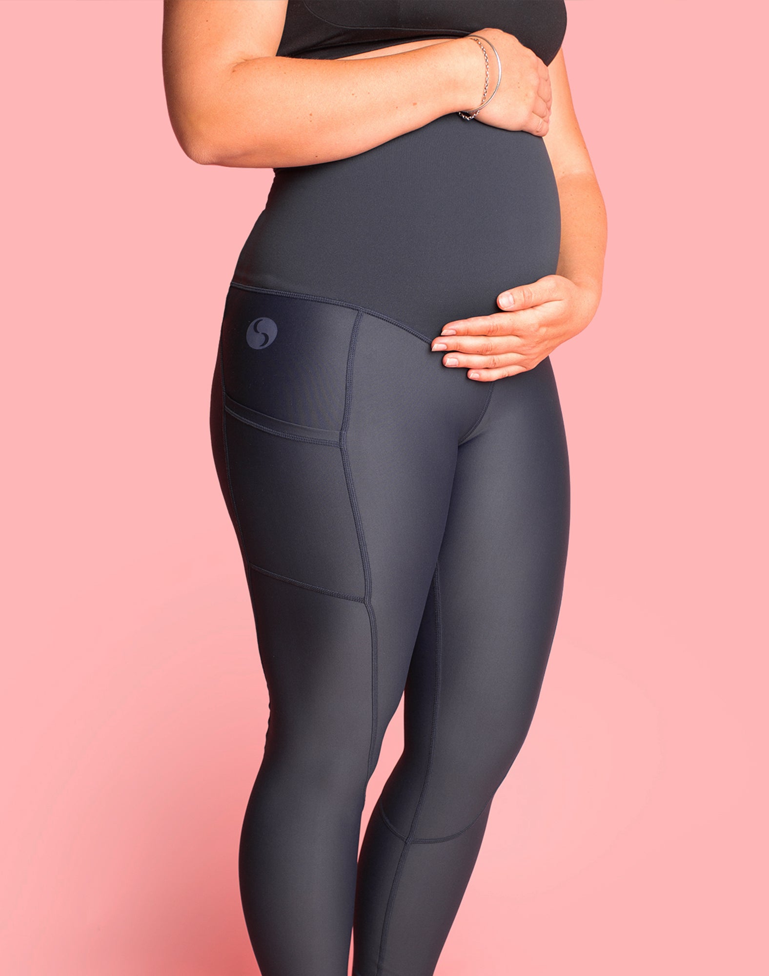 Side view of expecting mother wearing high waisted pregnancy leggings