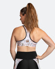 Back view of fit mum wearing white floral with black trim maternity matching co-ordinates