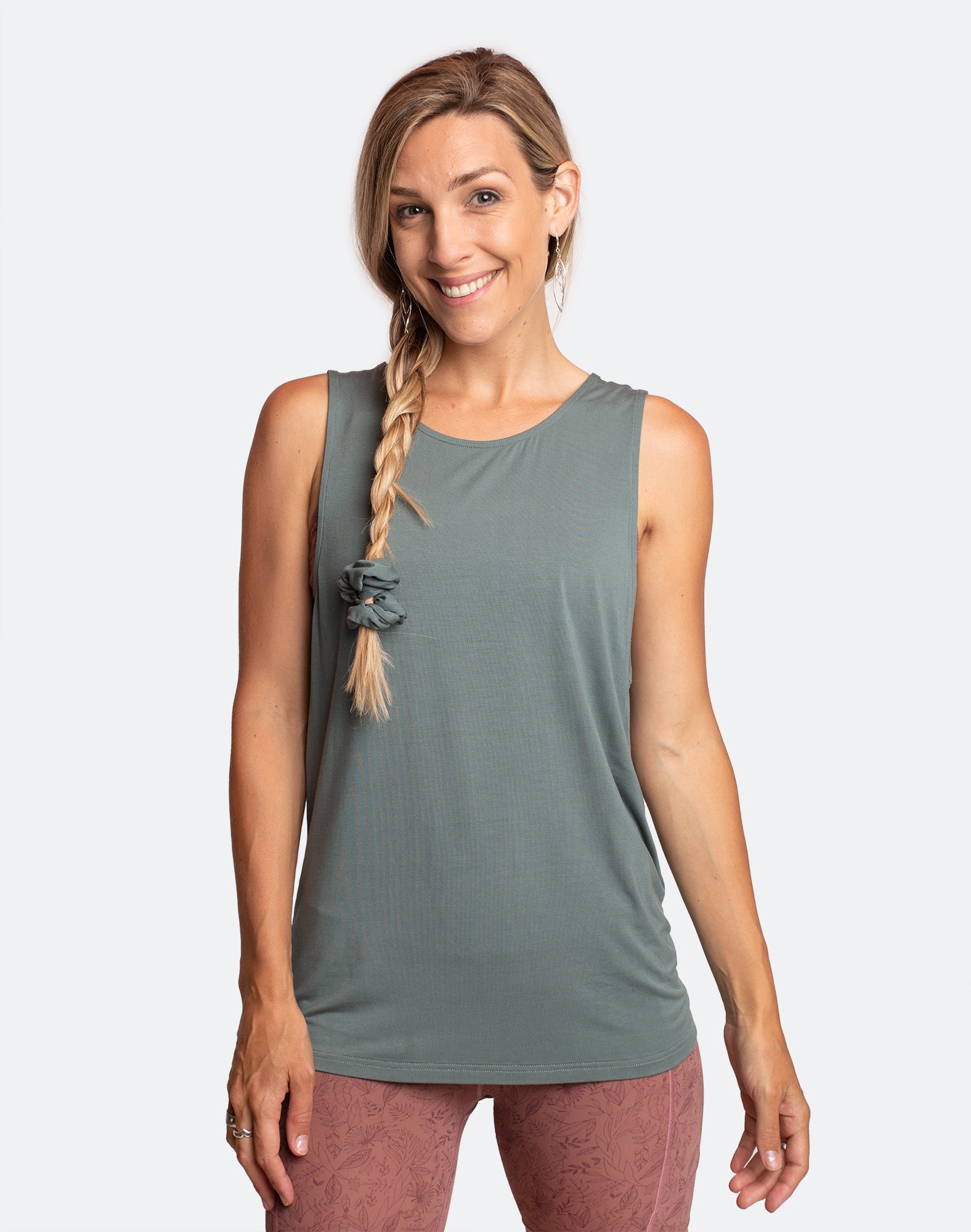 Active mother wearing a sage green summer nursing top