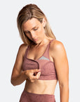 Active mother wearing a rose pink nursing bra