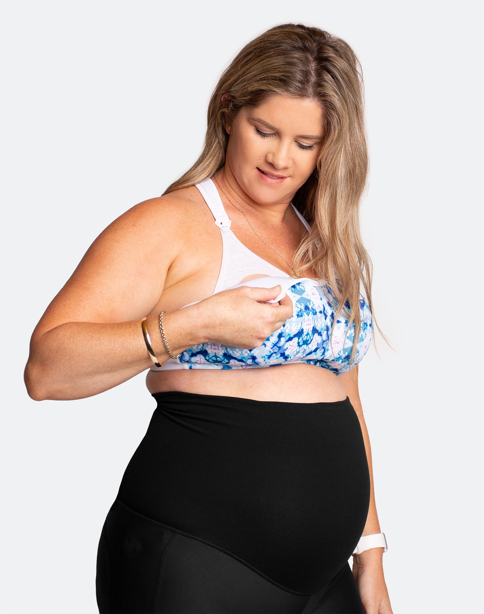 Pregnant mother showing the nursing function of a maternity nursing bra