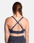 Back view of blue nursing sports bra with straps crossed over