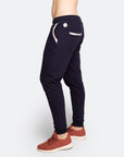 Side view of navy blue postpartum lifestyle trousers with white floral detailing on pocket