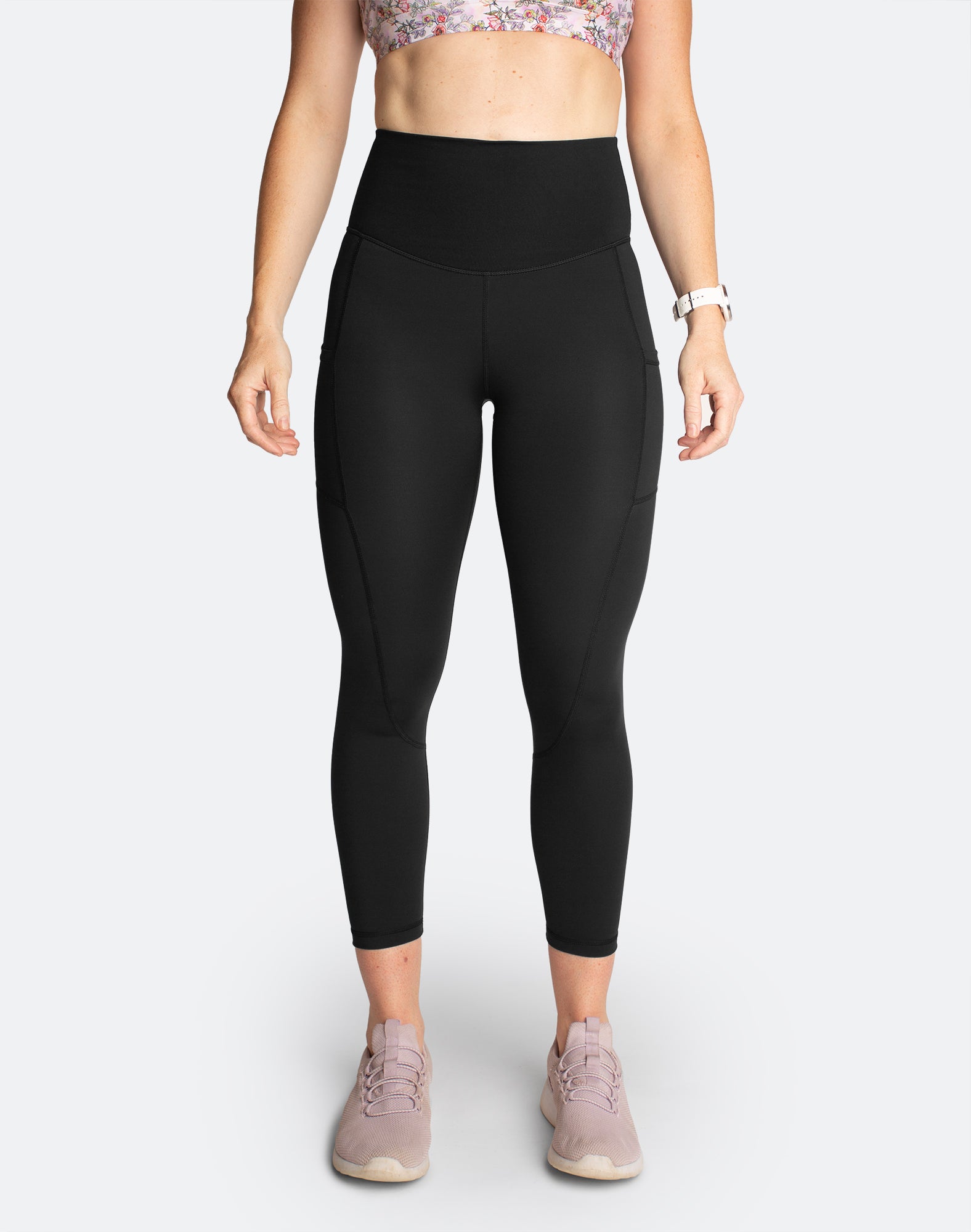 Front view of active mum wearing black postpartum high waisted leggings