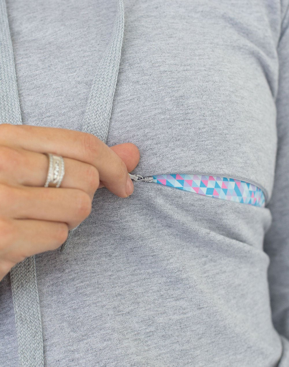 close up of a grey casual breastfeeding hoodie with one invisible zip unzipped