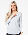 front view of a mum wearing a grey maternity top with long sleeves