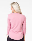 back view of a mum in a pink maternity top with long sleeves