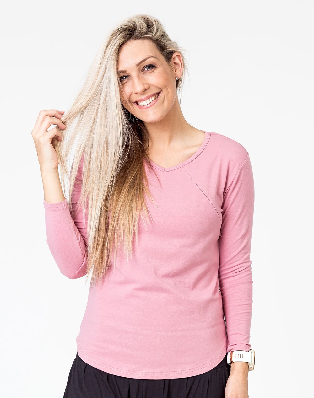 active mum wearing a pink maternity top with long sleeves and invisible zips for breastfeeding