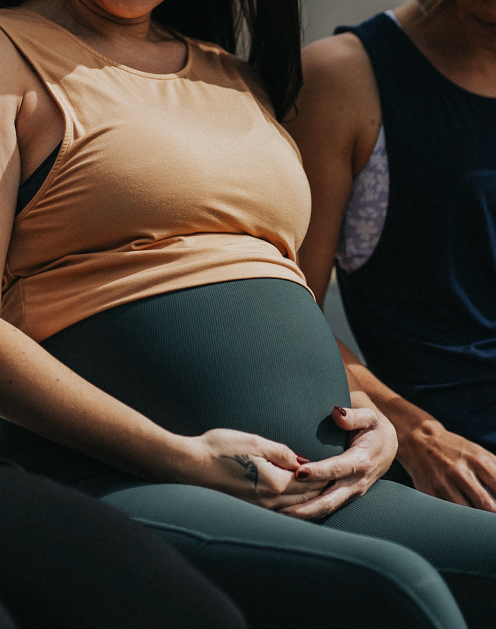 Close up of ribbed dark green maternity leggings