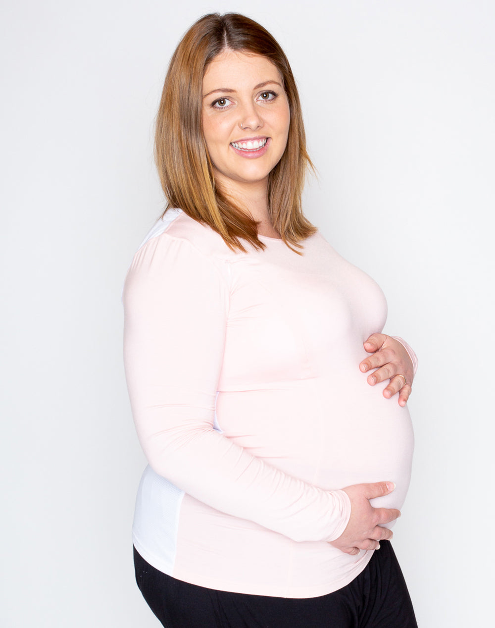 pregnant woman wearing a maternity top and leggings