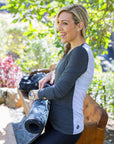 back view of a mum wearing a grey and white maternity top with long sleeves