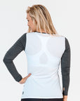 side view of a mum wearing a grey and white maternity top with long sleeves