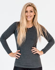 front view of an active mum wearing a grey maternity top with long sleeves