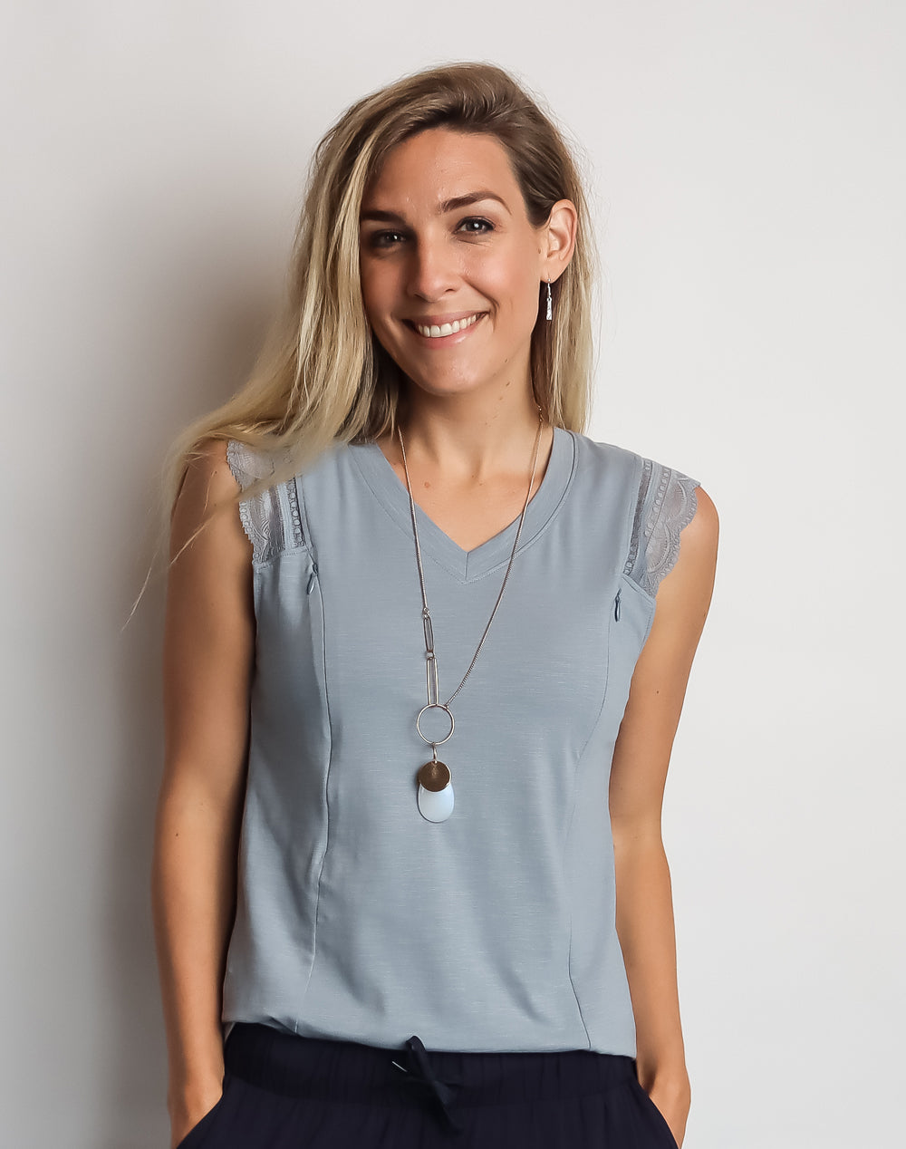 Happy mother wearing light blue dressy maternity top