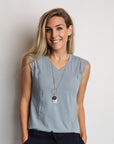 Happy mother wearing light blue dressy maternity top