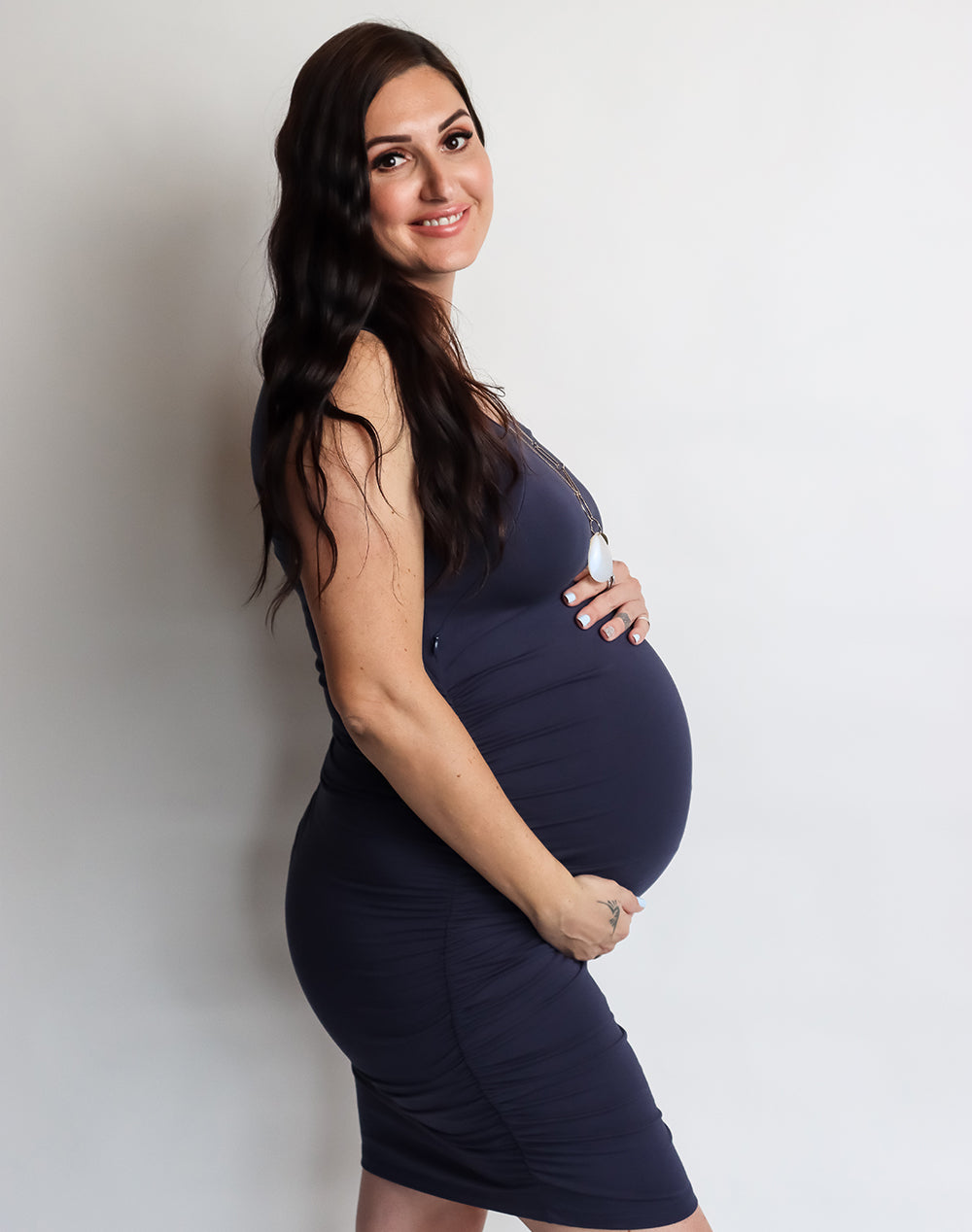 Pregnant mum wearing navy maternity & breastfeeding dress