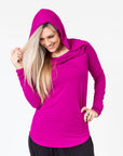 front view of a mum wearing a mulberry colour breastfeeding hoodie with the hood up