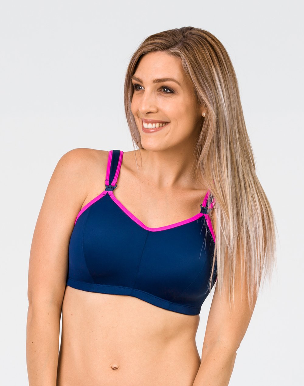 front view of a mum in a navy nursing sports bra with pink lining 