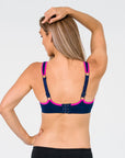 back view of mum wearing a navy nursing sports bra with option to wear as a normal bra