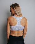 Back view of floral racerback sports crop bra