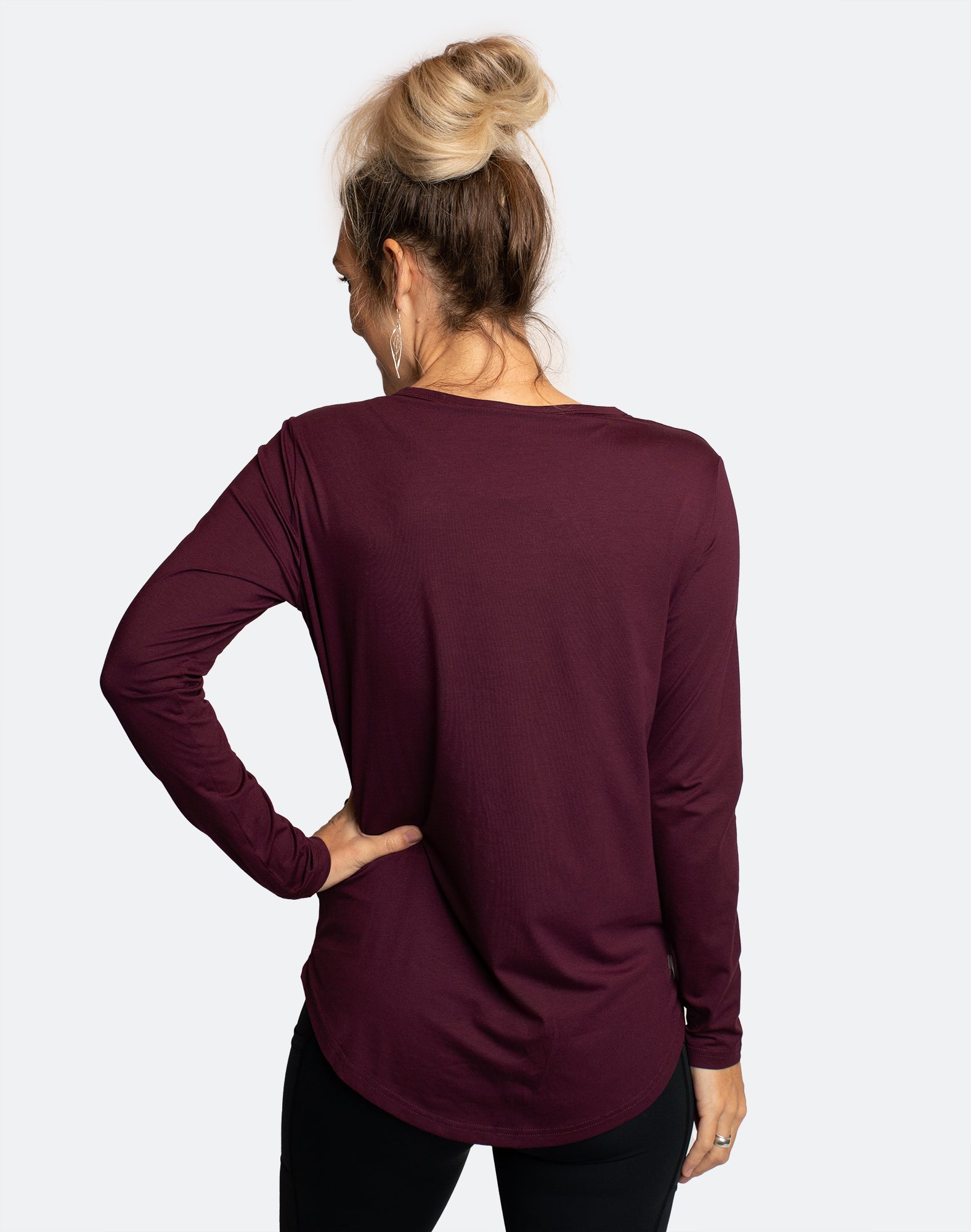 back view of active mum wearing breastfeeding long sleeve maternity top