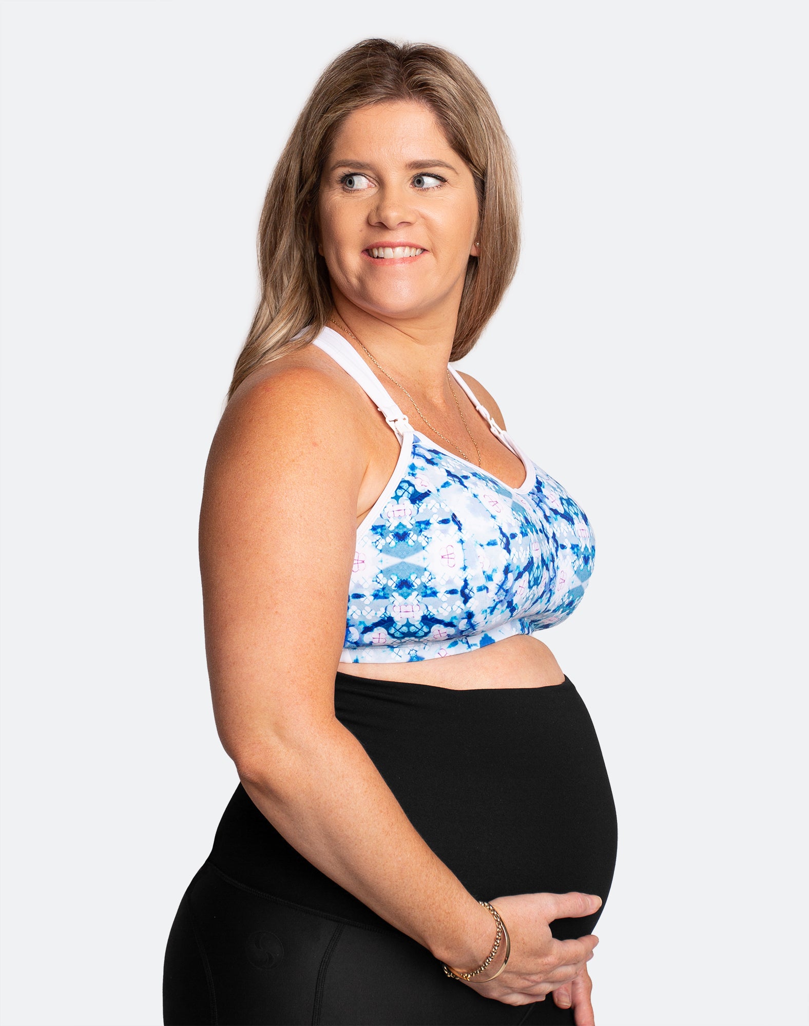 Side view of happy, pregnant mother wearing maternity activewear