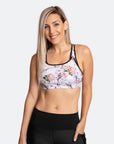 Front view of active mum wearing white floral nursing bra with black trim