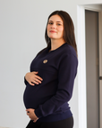 Pregnant mother wearing maternity breastfeeding navy crew neck jumper