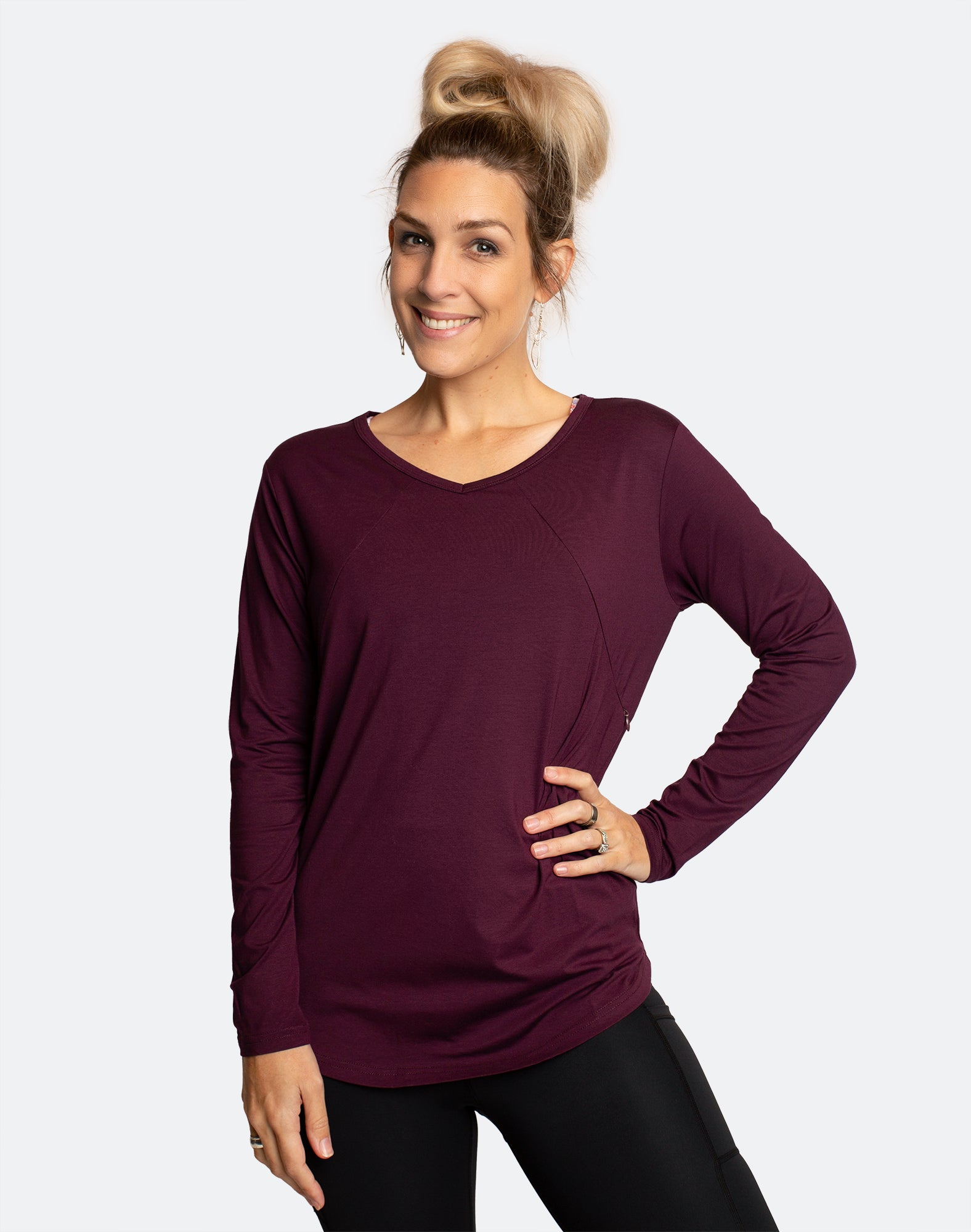 active mum wearing breastfeeding long sleeve top in dark purple demonstrating nursing function