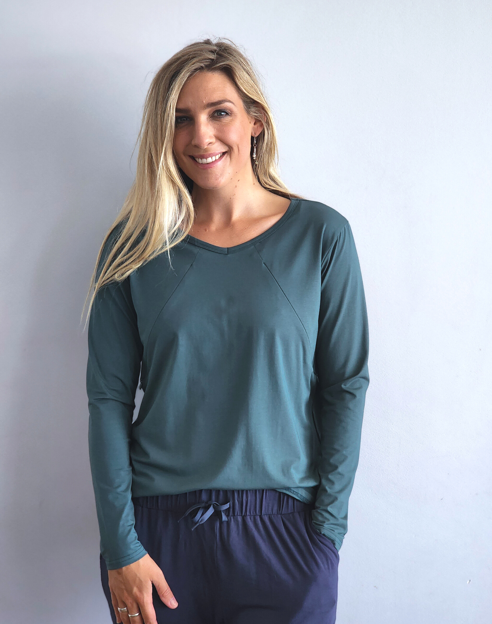 Active mum wearing a green nursing long sleeve top