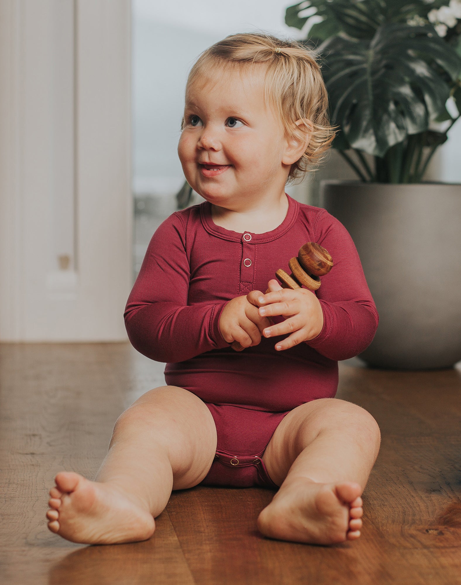 Pink bamboo baby long sleeve onesie with domes